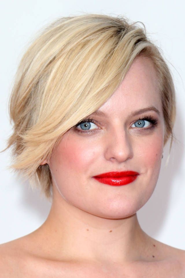 Elisabeth Moss in red lipstick posing for camera and showing her asymmetrical golden bob - hollywood actress haircut