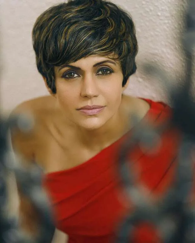 Mandira Bedi in one shoulder red dress posing for camera and showing her pixie hairstyle - latest hair cut for girls