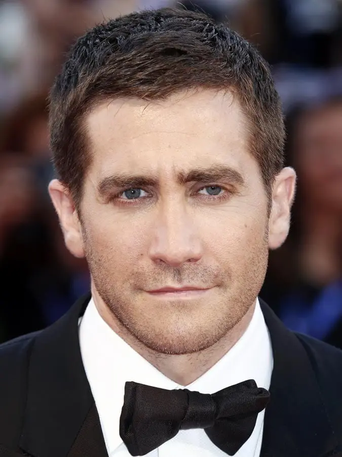 Jake Gyllenhaal in black coat with white shirt and black bow tie showing his Textured Crop hairstyle - Hollywood heros hairstyle