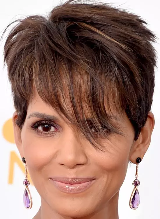 Smiling Halle Berry in purple stone earrings posing for camera and showing her layered pixie - hollywood actress haircut