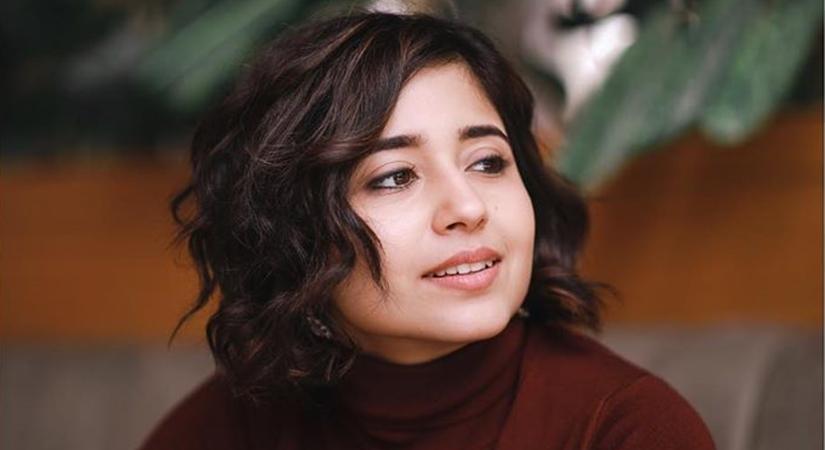 Shweta Tripathi in maroon high neck top posing for camera and showing her razor cut - latest hair cut for girls