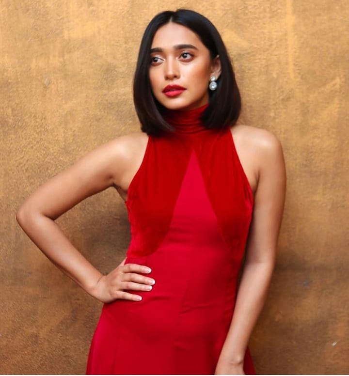 Sayani Gupta in red cut sleeves dress posing for camera and showing her blunt and neat lob - hair cut for girls