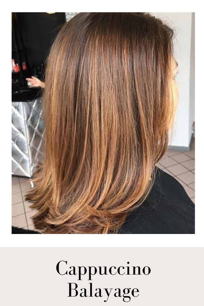 A girl in black top showing the side view of her Cappuccino Balayage - golden red hair color