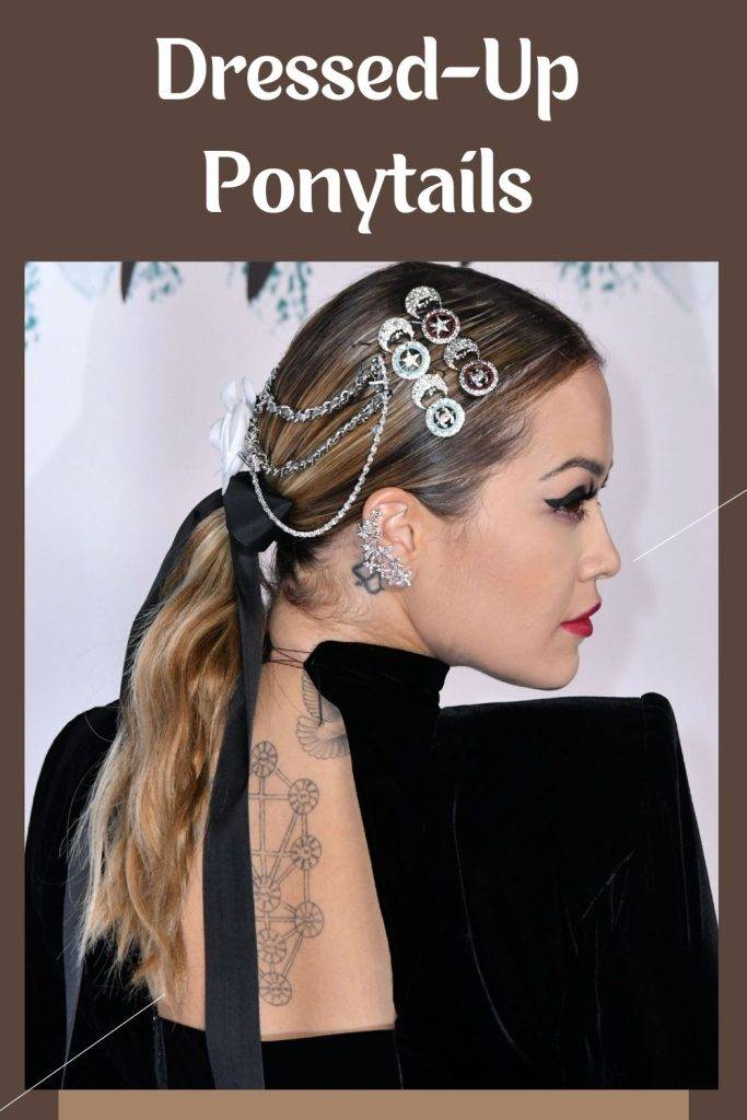 A girl in black deep neck dress with tattoo on her back posing for camera and showing her Dressed-Up Ponytail - ponytail hairstyles for women