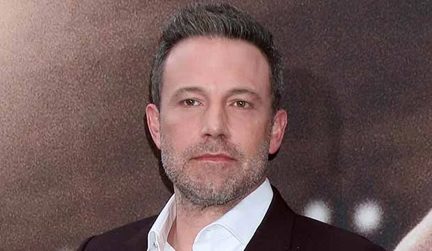 Ben Affleck in white shirt with black coat posing for camera - hollywood dental implants