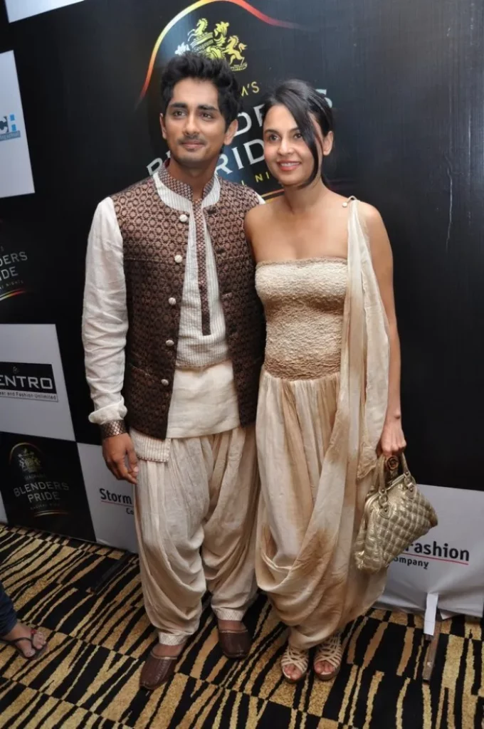 Siddharth Narayan in white kurta with brown jacket and Meghna Narayan in off shoulder off white dress posing for camera - Aries compatibility signs