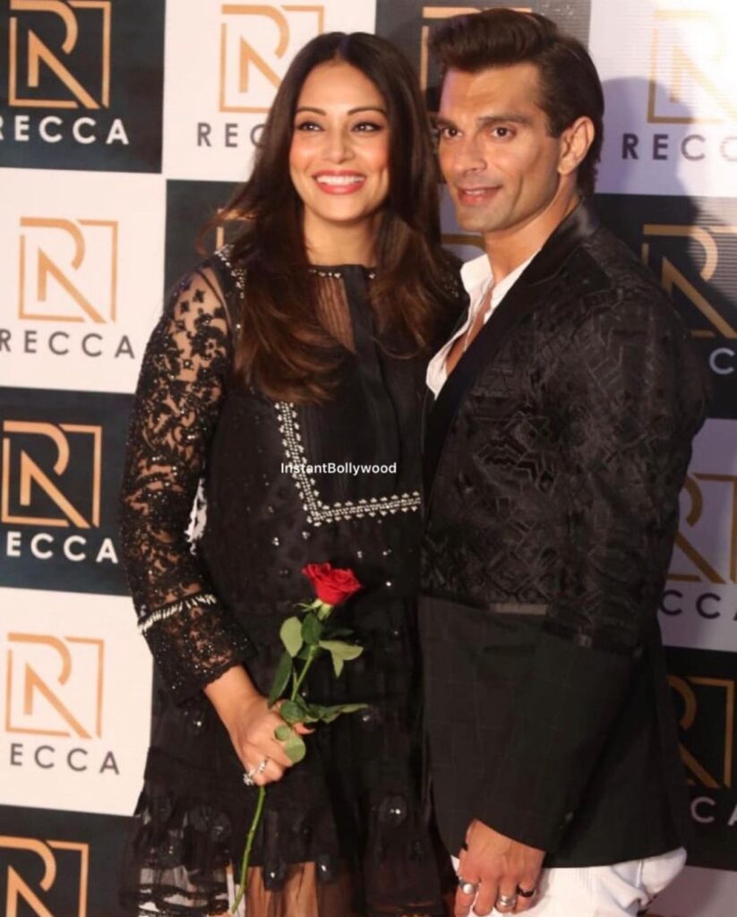 Smiling Bipasha Basu and Karan Singh Grover in black matching outfit posing for camera - Capricorn best compatibility