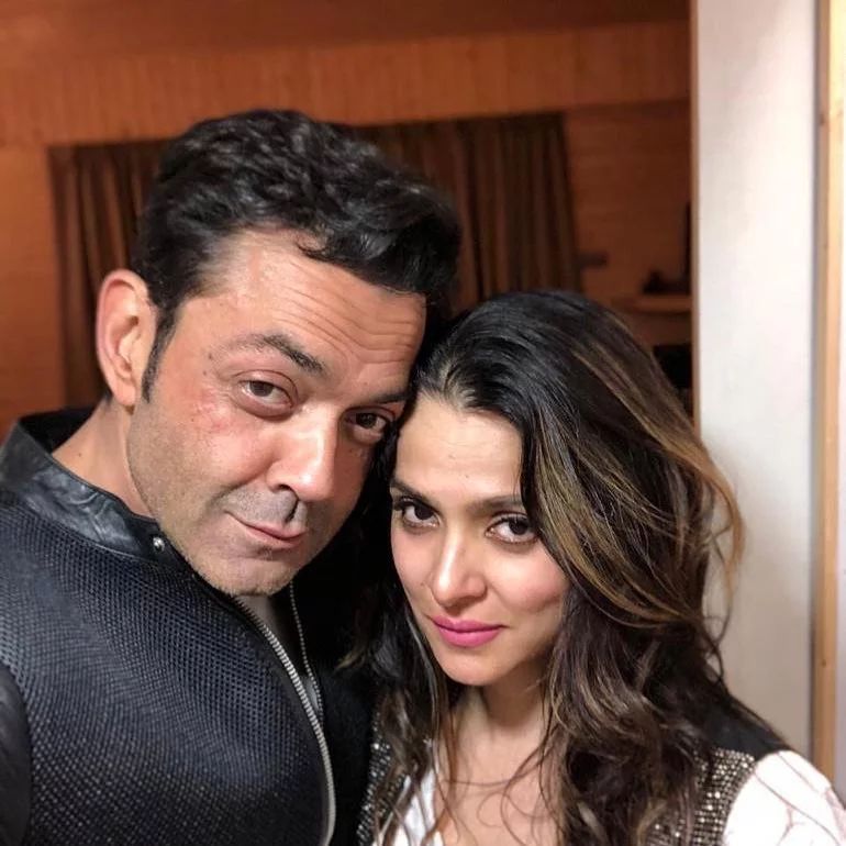 Bobby Deol in black jacket and Tanya Deol in pink and black dress posing for a selfie - best partner for July born
