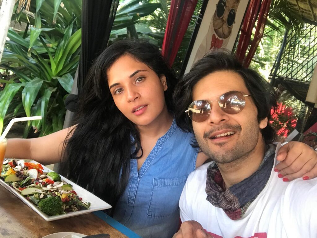 Richa Chadda in blue denim dress and  Ali Fazal in white t-shirt with googles having lunch and posing for a selfie - Sagittarius compatibility
