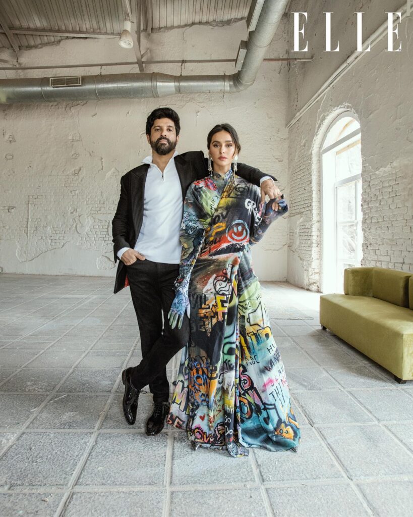Farhan Akhtar in black suit with white shirt and Shibani in multi color long dress posing for camera - Capricorn compatibility signs