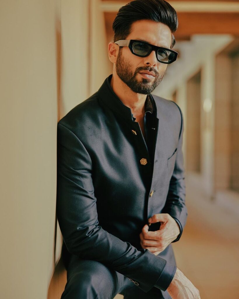 Shahid Kapoor in black suit with goggles posing for camera - Indian actors hairstyles