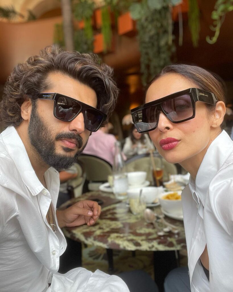 Arjun Kapoor and Malaika Arora in matching white outfit with goggles posing for a selfie - Cancer compatibility friendship
