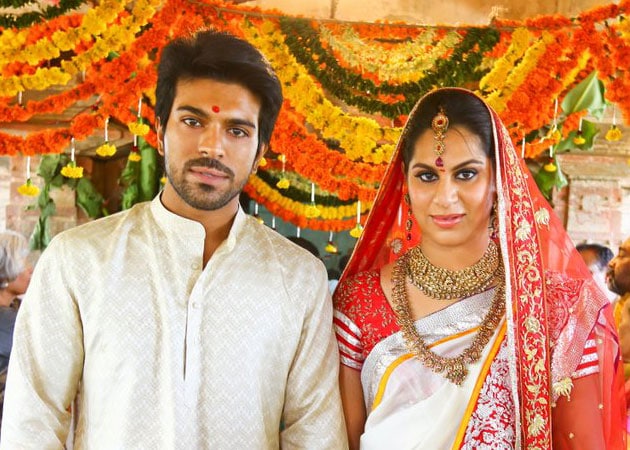 Ram Charan Teja in off white kurta and  Upasana Kamineni in red and off white saree with red dupatta posing for camera - Aries compatibility friendship