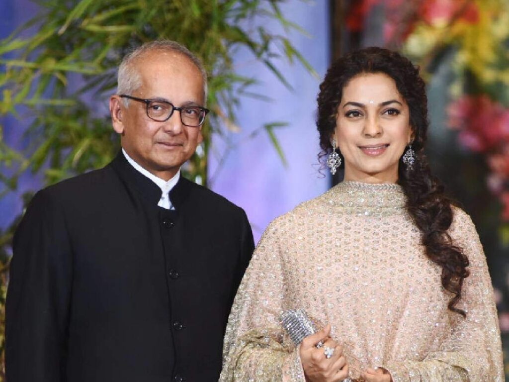 Juhi Chawla in pink suit and Jay Mehta in black coat posing for camera - facts for November Born