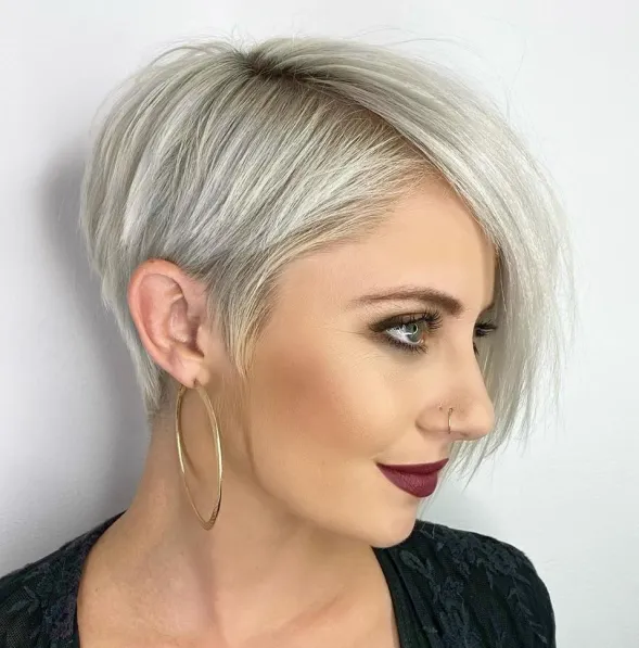 Woman in black dress with maroon lipstick and hoops earrings and showing her Asymmetrical Tapered Pixie - short hairstyles ladies