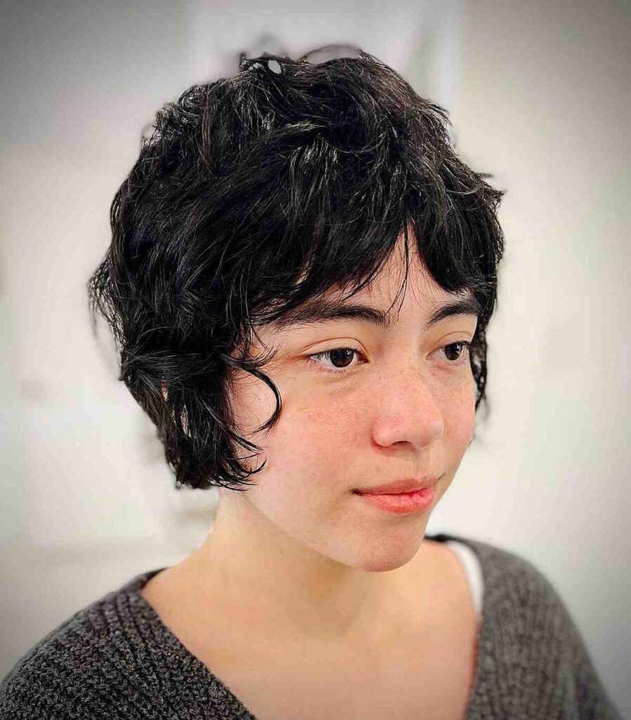 Woman in grey pullover and Jet black long shaggy pixie with curtain hairstyle - short hairstyles 2022