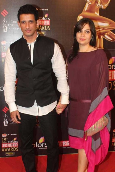 Sharman Joshi in white shirt with black waist coat and Prerana Chopra in brown kaftan dress posing for camera - facts for May Born