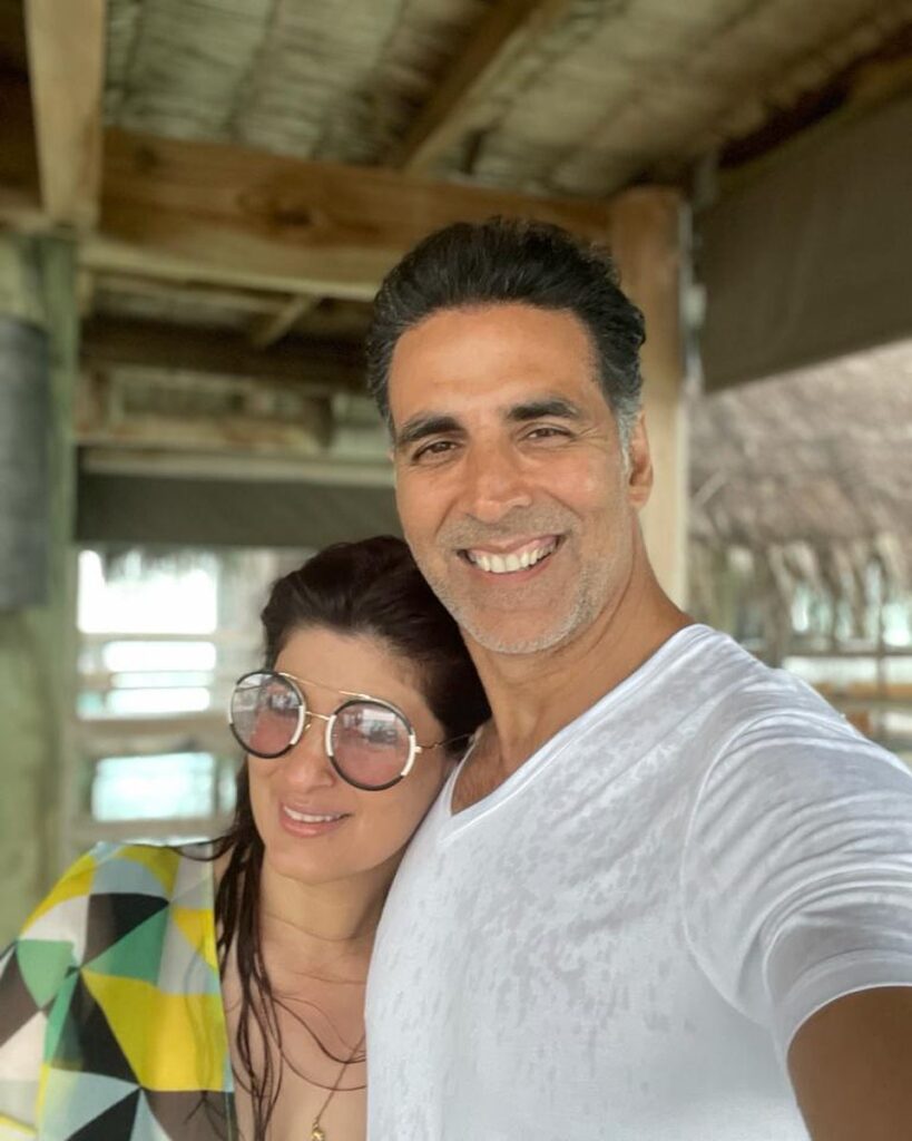 Akshay Kumar in white t-shirt and Twinkle Khanna in multi color dress with goggles posing for selfie - Virgo compatibility signs