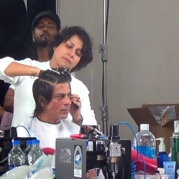 A lady is trimming Shahrukh Khan hair - Shahrukh Khan hair cut