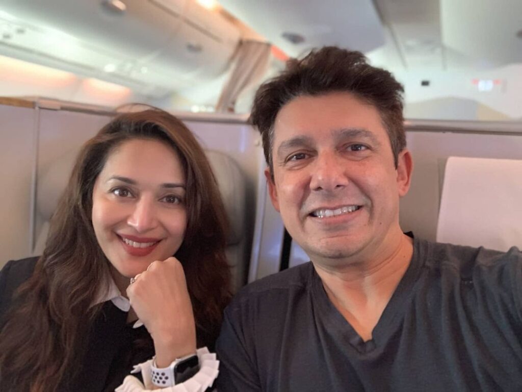 Madhuri Dixit in black and white top and Shri Ram Nene in grey t-shirt posing for a selfie - Taurus compatibility signs