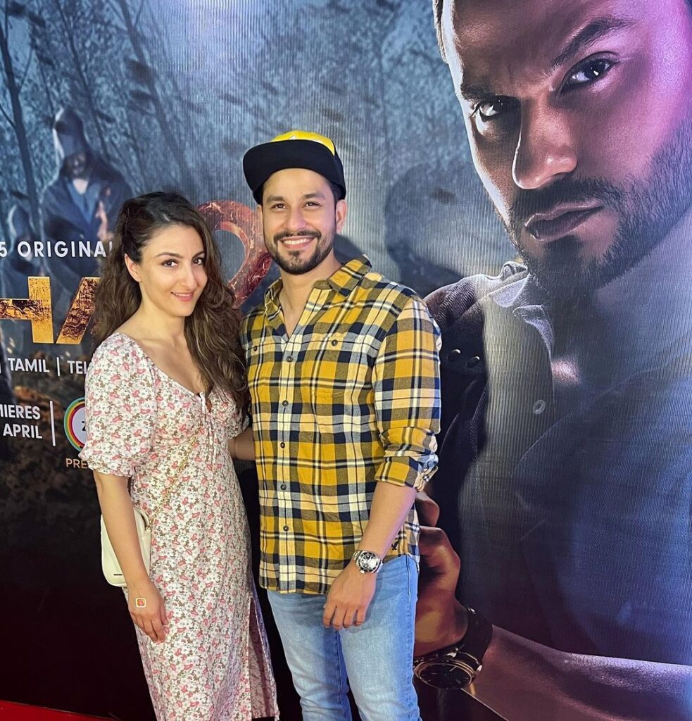 Soha Ali Khan in multi color dress and Kunal Kemmu in check shirt with blue jeans and cap posing for camera - Libra compatibility for love