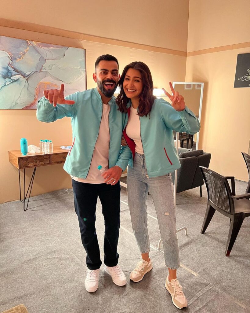 Smiling Virat Kohli and Anushka Sharma in matching sky blue outfit posing for camera - Scorpio compatibility