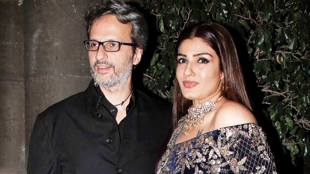 Raveena Tandon in blue and golden saree with necklace and Anil Thadani in black suit posing for camera - best match for Scorpio