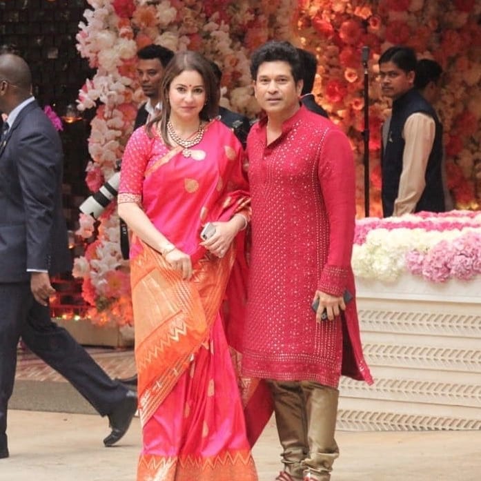 Sachin Tendulkar in pink kurta pyjama and Anjali in matching pink and golden saree posing for camera - best partner for May born