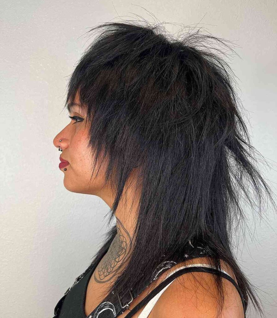 Woman in black strappy dress showing the side view of her Shagged Mullet with Spiky Ends - mullet haircut for women