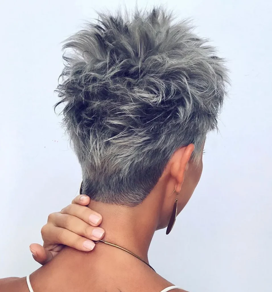 Woman showing the back view of her Shaggy Pixie haircut - Funky Undercut Pixie 