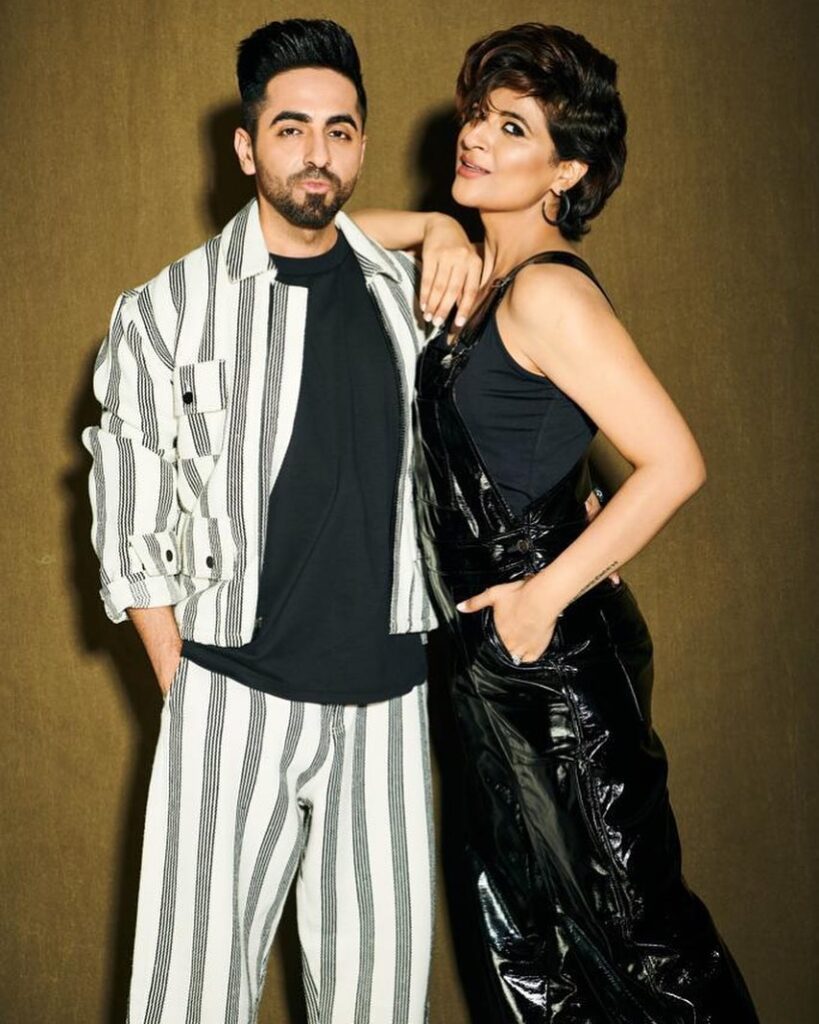 Ayushmann Khurrana in black and white lining suit and Tahira in black outfit posing for camera - facts for September Born