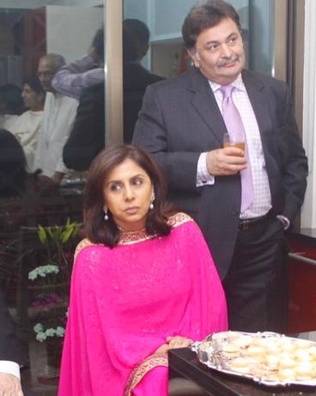 Rishi Kapoor in blue suit with white shirt and Neetu Singh in pink suit posing for camera - Virgo best compatibility
