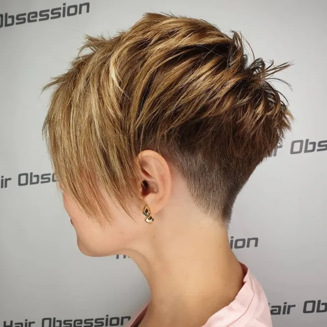 Woman in peach top with golden earring and Highlighted Pixie Undercut - pixie bob hairstyles