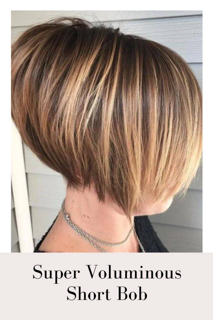 Woman in black top with silver chains and Super Voluminous Short Bob - bob hairstyles for girls