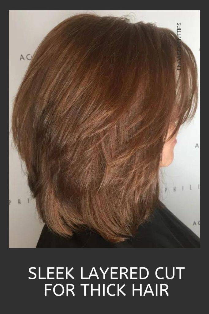 Woman in black dress showing the side view of her sleek layered cut - haircut round face