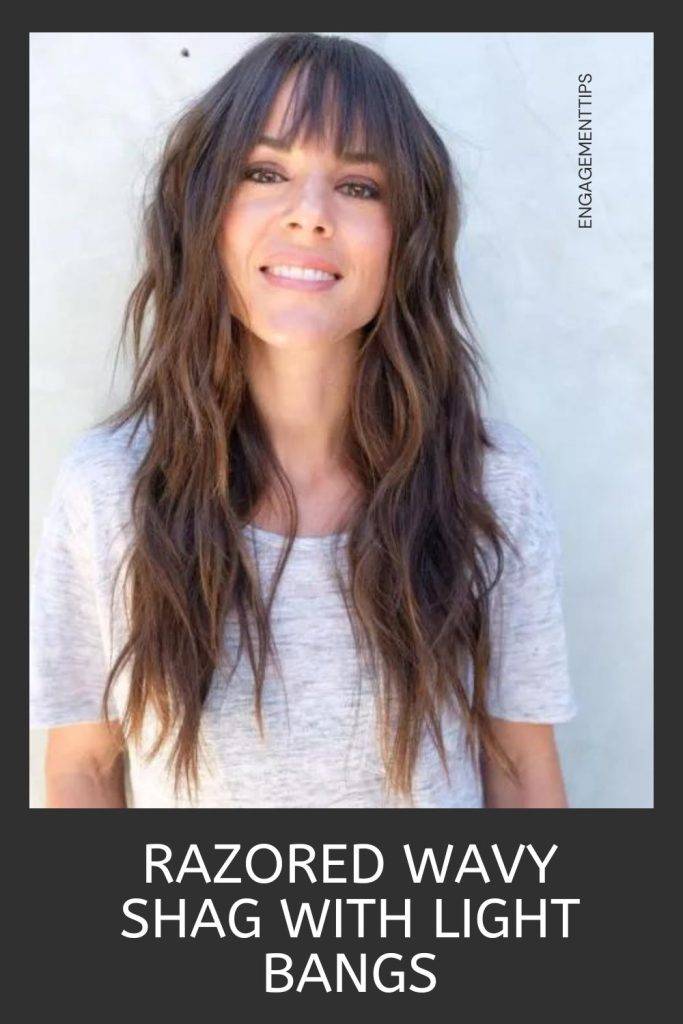 Woman in white t-shirt and razored wavy shale with light bangs hairstyle - shag haircut round face