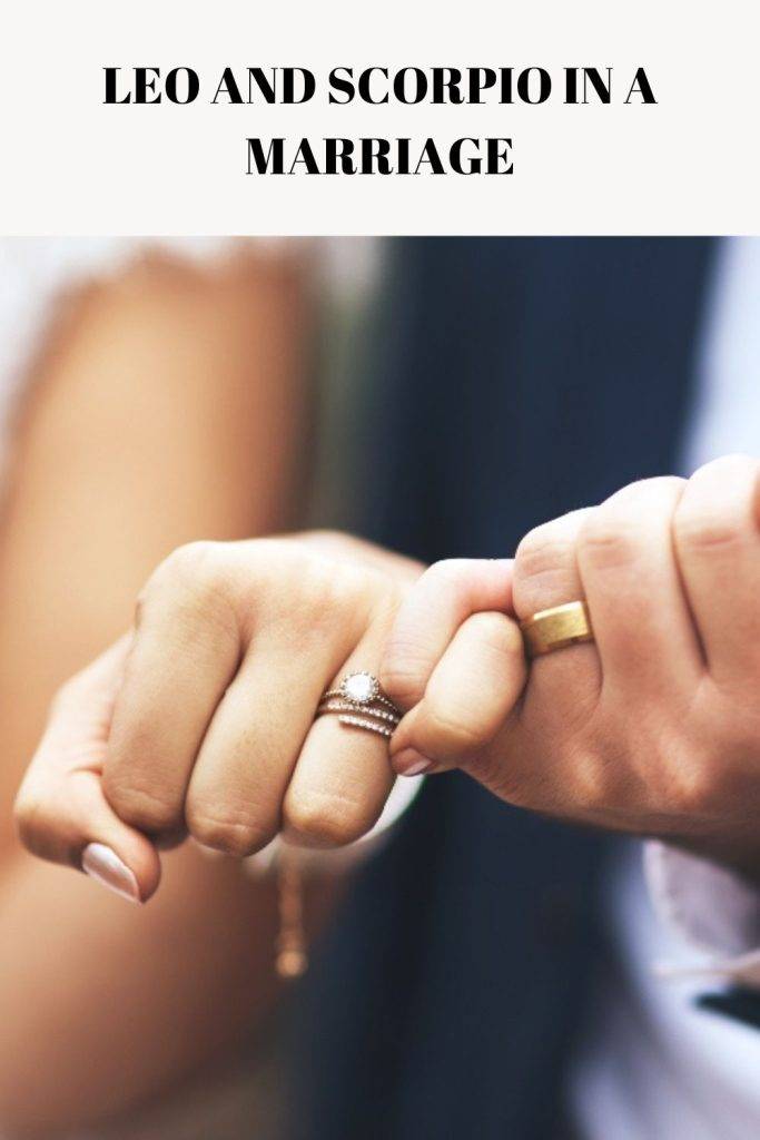 A couple holding each other hand and showing their wedding rings - Leo Compatibility with Scorpio