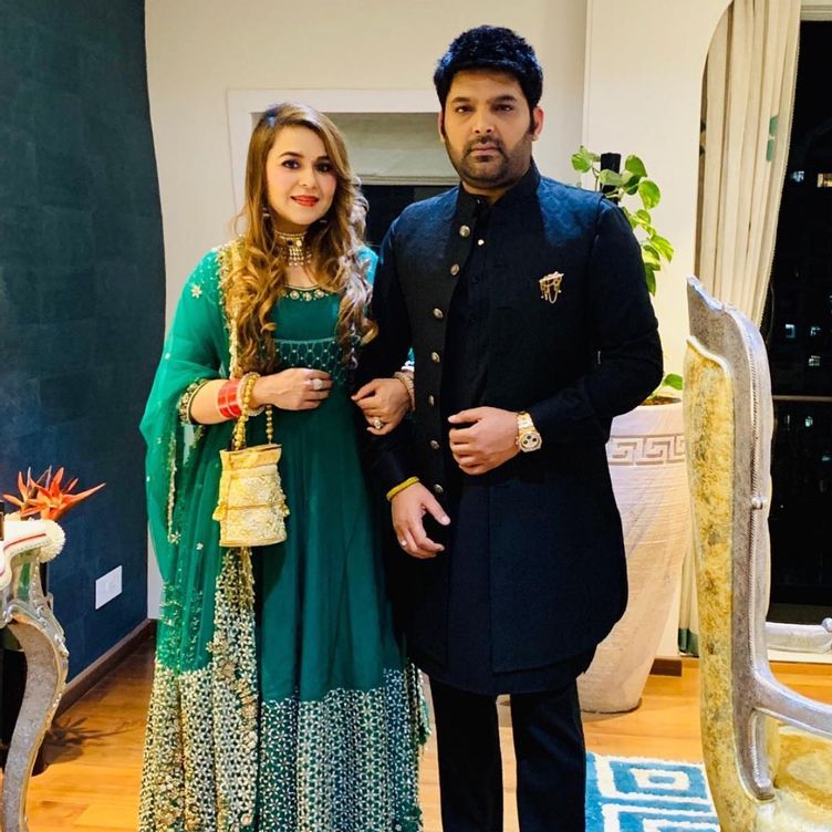 Kapil Sharma and Ginni Chatrath posing for camera in traditional outfit - Aries and Scorpio Compatibility