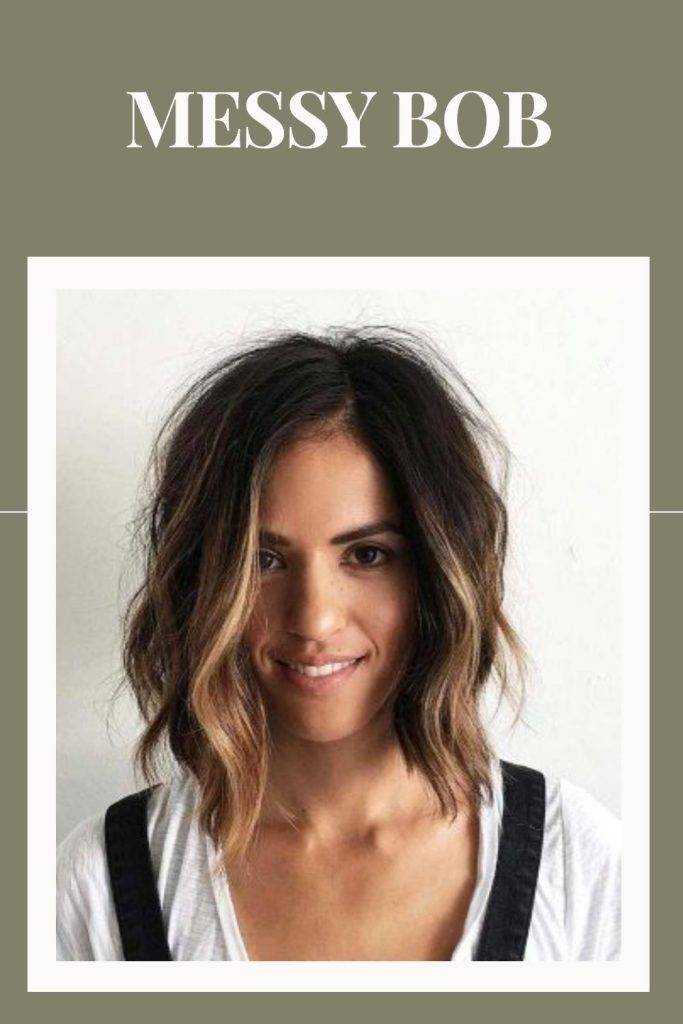 woman in white and black deep neck top with messy bob - short hairstyles for women