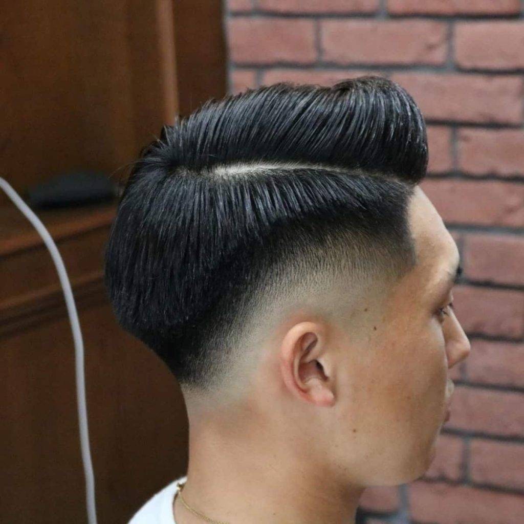 side view of high fade comb over hairstyle for guys