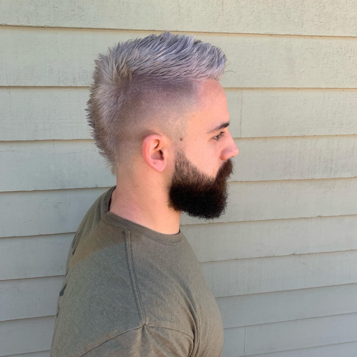 grey high fade faux hawk hairstyle for men