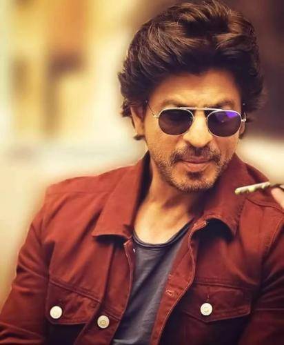 Shahrukh khan in red shirt with goggles and medium hairstyle