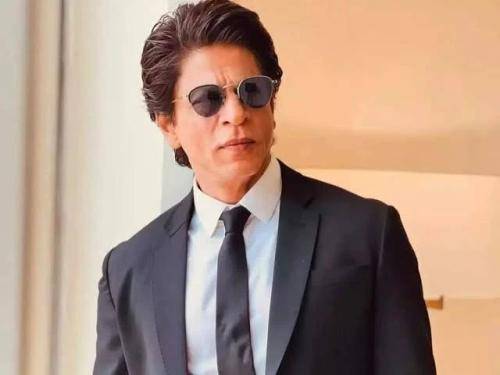 Shahrukh khan in black suit with white shirt and gelled regular medium hairstyle