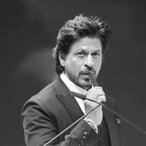 Shahrukh khan in grey suit with white shirt and medium hair