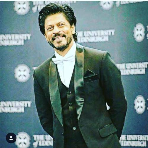Shahrukh khan in black suit with white shirt and gelled hairstyle