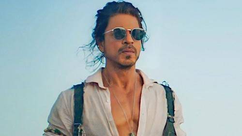 Shahrukh khan in white shirt with messy men bun