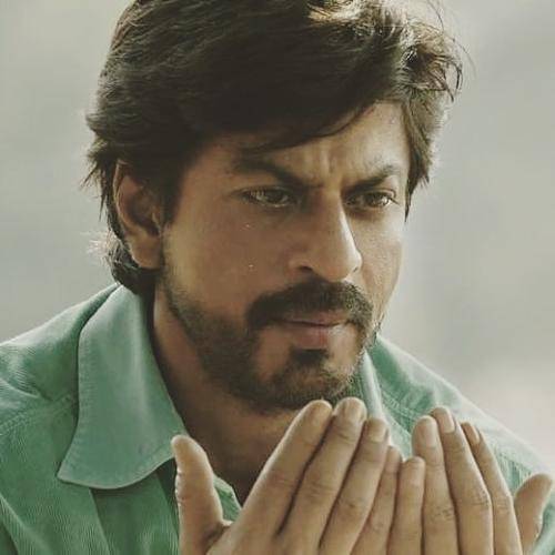 Shahrukh khan in green shirt and messy medium hairstyle with beard