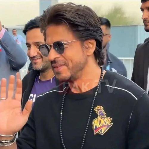 Shahrukh khan in black round neck t-shirt with slicked back hairstyle