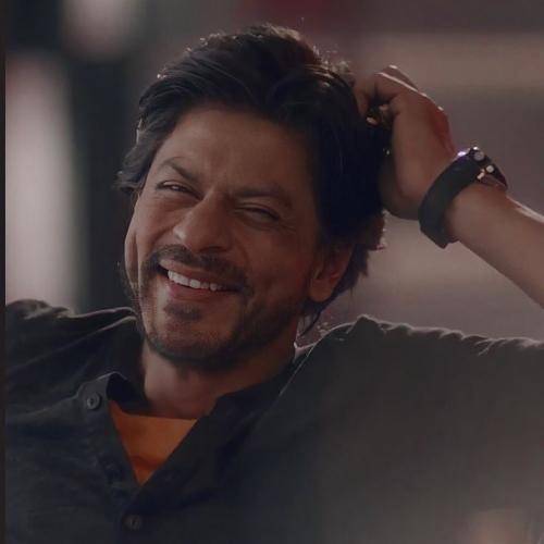 Shahrukh khan in black shirt and side parted medium hairstyle