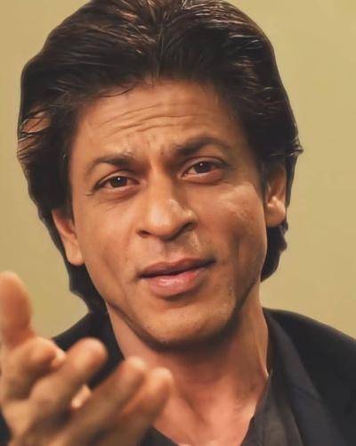 Shahrukh khan in black outfit and side parted colored medium hairstyle